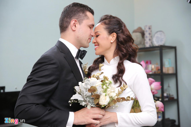 Trong lễ rước dâu, Phương Mai diện áo dài trắng phom dáng truyền thống, in họa tiết cánh sen và cá chép. Trang phục do một người bạn thân của cô thiết kế.