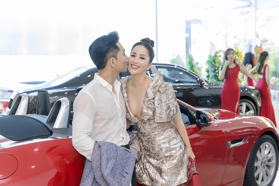 Tại sự kiện, Khánh Thi diện váy sequin xẻ ngực sâu. Bộ cánh giúp ‘kiện tướng dance sport’ khoe được vòng 1 gợi cảm dù đã trải qua hai lần sinh nở. Ông xã Phan Hiển lại lịch lãm diện vest để tương xứng với phong cách quyến rũ của vợ. Trước ống kính cùng sự chú ý của nhiều quan khách, cặp đôi không ngần ngại thể hiện những cử chỉ tình tứ như nắm tay, hôn má.