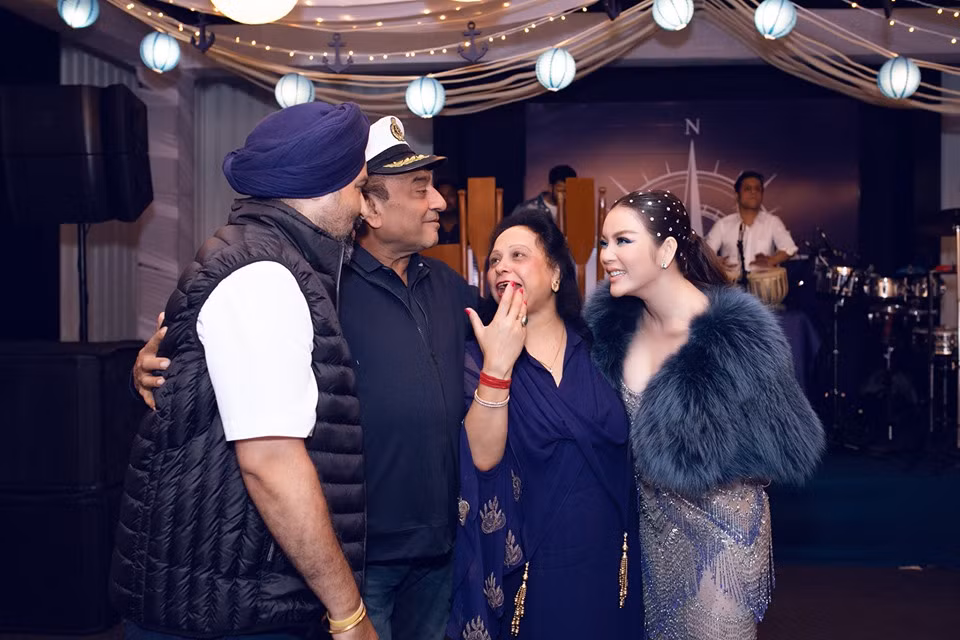 Nữ diễn viên được bố mẹ nuôi đưa đi giới thiệu với các khách mời trong đêm tiệc.