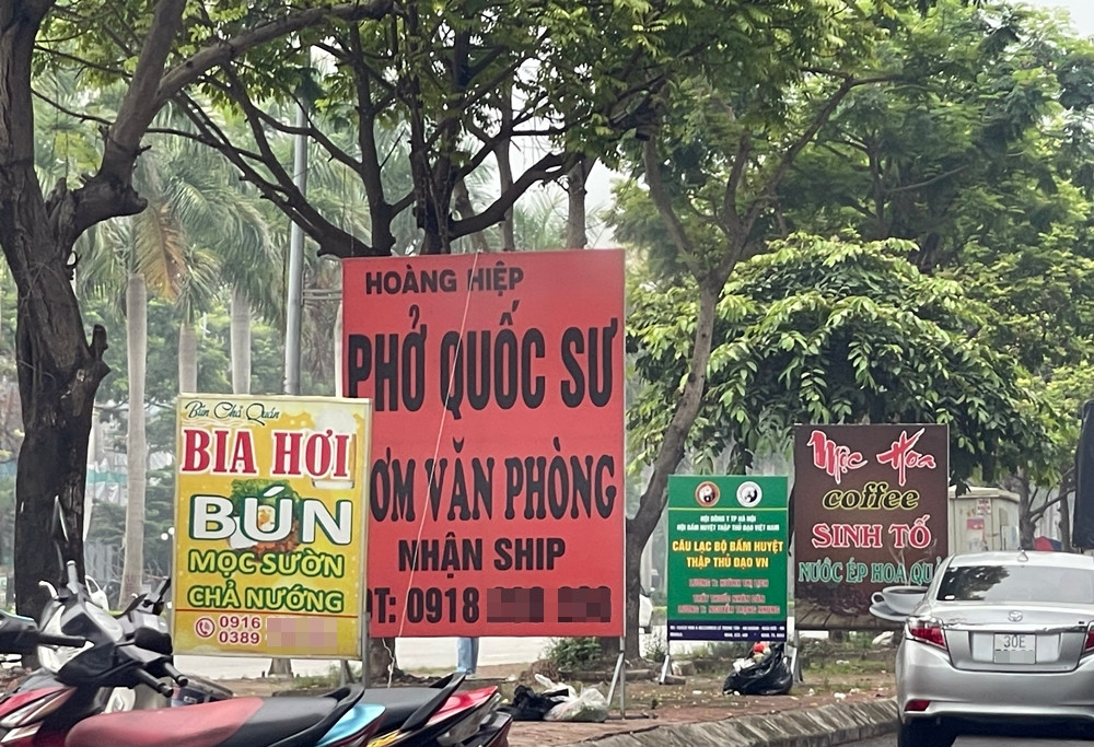 Bảng quảng cáo đặt tràn lan trên vỉa hè tuyến đường.