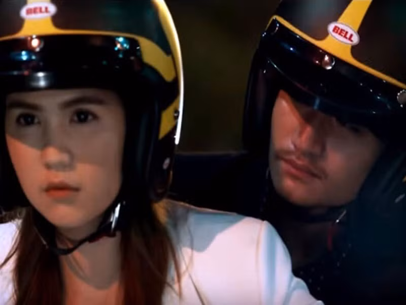 Chân dài tiếp tục bỏ tiền túi sản xuất và đóng vai chính dự án phim ngắn Giải mã NT56. Diễn xuất của Ngọc Trinh bị nhiều cư dân mạng chê bai. Trong cảnh lái xe mô tô phân khối lớn chạy trốn khỏi băng đảng xã hội, người đẹp 8x trông rất ngầu, không hề tỏ ra sợ hãi. Ảnh: Phụ Nữ và Gia Đình.