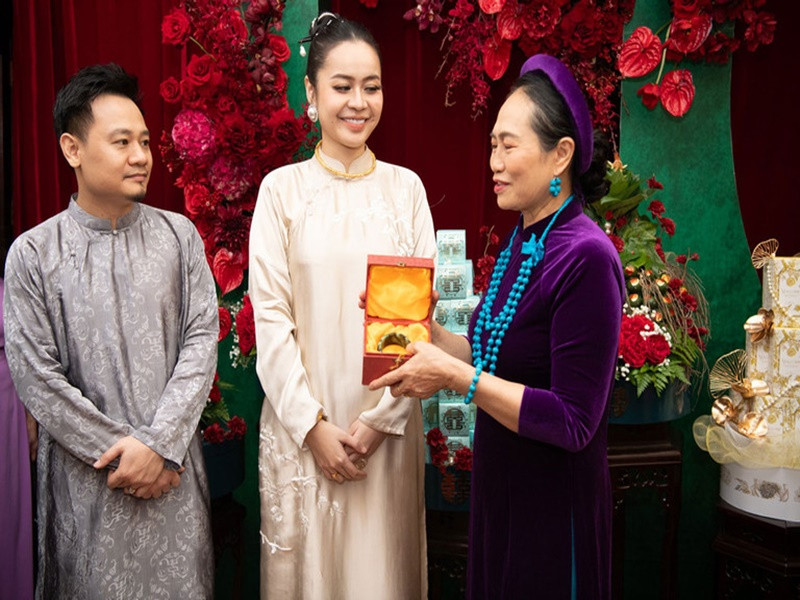 Theo Vietnamnet, Vũ Hạnh Nguyên nhận nhiều vàng trong lễ ăn hỏi. Trong ảnh, cô được mẹ ruột tặng chiếc kiềng vàng 1,5 cây và vòng ngọc trị giá 20.000 USD (gần 500 triệu đồng). Ảnh: Vietnamnet.