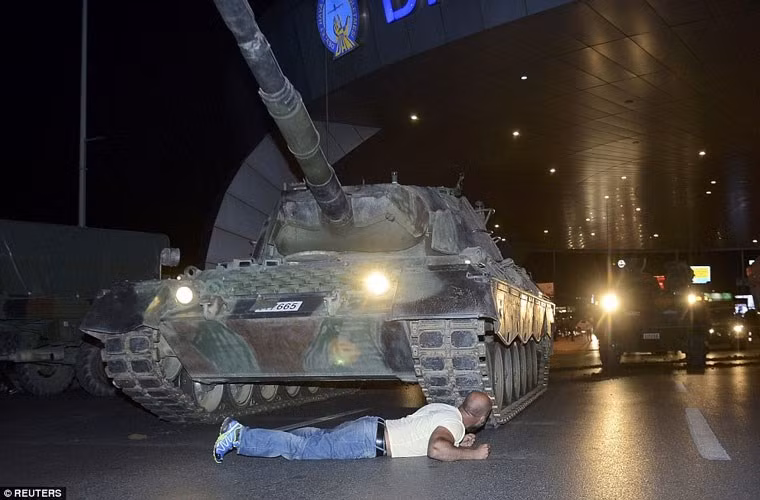 Trên đường phố Thổ Nhĩ Kỳ sau đó xuất hiện hàng chục xe tăng, xe bọc thép, xe tải chở quân cùng binh lính. Qua các hình ảnh được công bố, có tới ít nhất ba loại xe tăng đã được quân đảo chính sử dụng để chính biến quân sự. Ảnh: Xe tăng Leopard 1 bị chặn bởi một người biểu tình phản đối đảo chính.