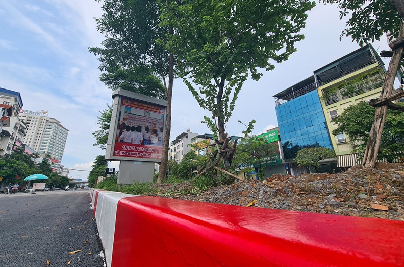 Một phần đường đã hoàn thiện, lớp sơn đỏ trắng được phủ mới lên dải phân cách làm bằng những khối bê tông đúc sẵn.