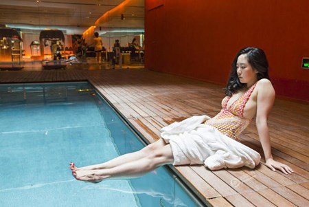 Một quý cô thuộc tầng lớp thượng lưu Trung Quốc ngồi thư giãn bên hồ bơi sang trọng.