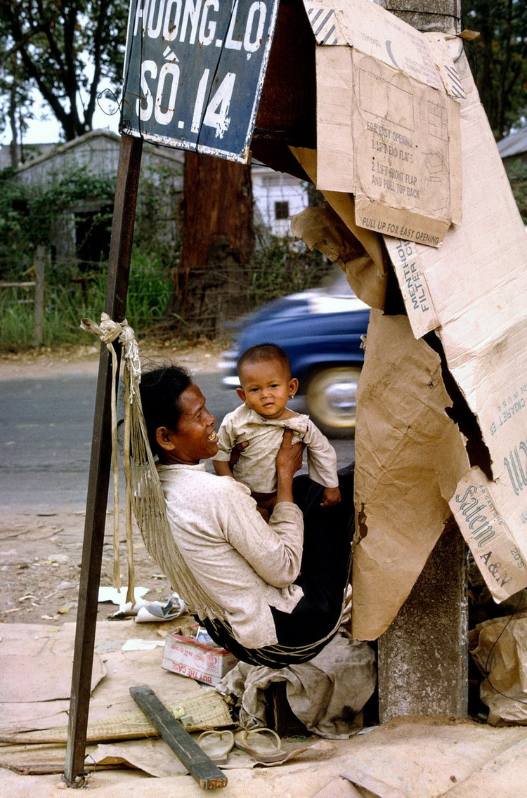Hai mẹ con người vô gia cư mắc võng nằm bên via hè Sài Gòn.