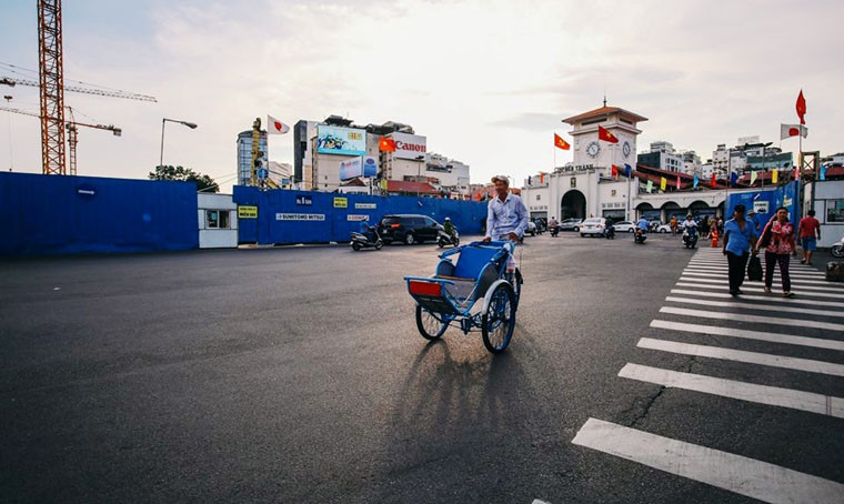 Bác tài xích lô thong dong trước chợ Bến Thành.