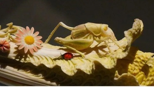 Trên "cây cải thảo" còn có một con châu chấu màu xanh và một con bọ rùa màu đỏ. Một vài bông hoa dại màu hồng được trang trí tỉ mỉ, tinh xảo ở phần thân của "cây cải thảo" quý hiếm.