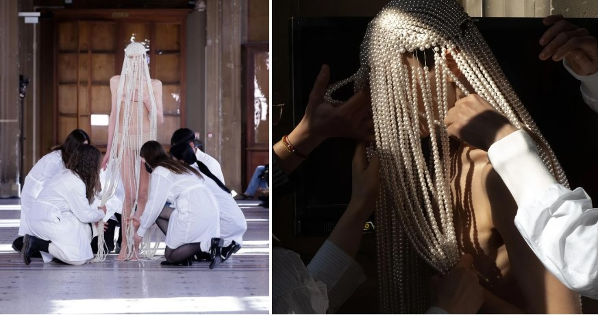 Trên sàn diễn của Kimhekim, người mẫu Jada Joyce xuất hiện với chiếc mũ được trang trí bằng các sợi dây ngọc trai, che kín mặt và cơ thể. Sau đó, các thành viên của ê-kíp nhà thiết kế bước lên sàn diễn, dùng kéo cắt đứt ngọc trai. Nhà thiết kế giải thích: "Ngọc trai trên dây đại diện cho những suy nghĩ và hành động bị hạn chế. Khi dây bị cắt, gánh nặng và giới hạn được lấy đi và bạn có thể tự do tận hưởng con người thật của mình". Ảnh: thomasdecruzmedia, chehovska.