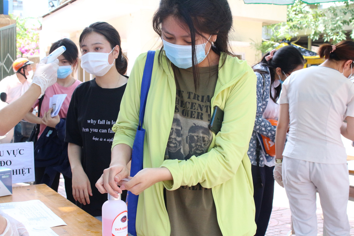 Trước khi bước vào phòng thi, các em học sinh đều được đo thân nhiệt, hướng dẫn rửa tay sát khẩn, và đeo khẩu trang.