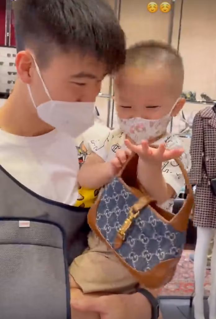 Buổi tối, Duy Mạnh đưa vợ con đi mua sắm. Khi ghé vào cửa hàng đồ hiệu, bé Ú tỏ ra thích thú với chiếc túi hiệu Gucci Denim giá khoảng 10 triệu đồng. Duy Mạnh cũng đùa với con: "Ú ưng là bố xuống tiền luôn". Ảnh: IGNV
