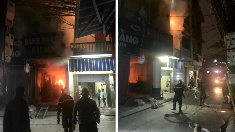 Canh sat giai cuu mot gia dinh mac ket trong dam chay luc rang sang