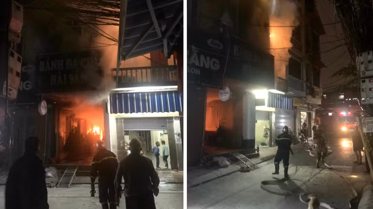 Canh sat giai cuu mot gia dinh mac ket trong dam chay luc rang sang