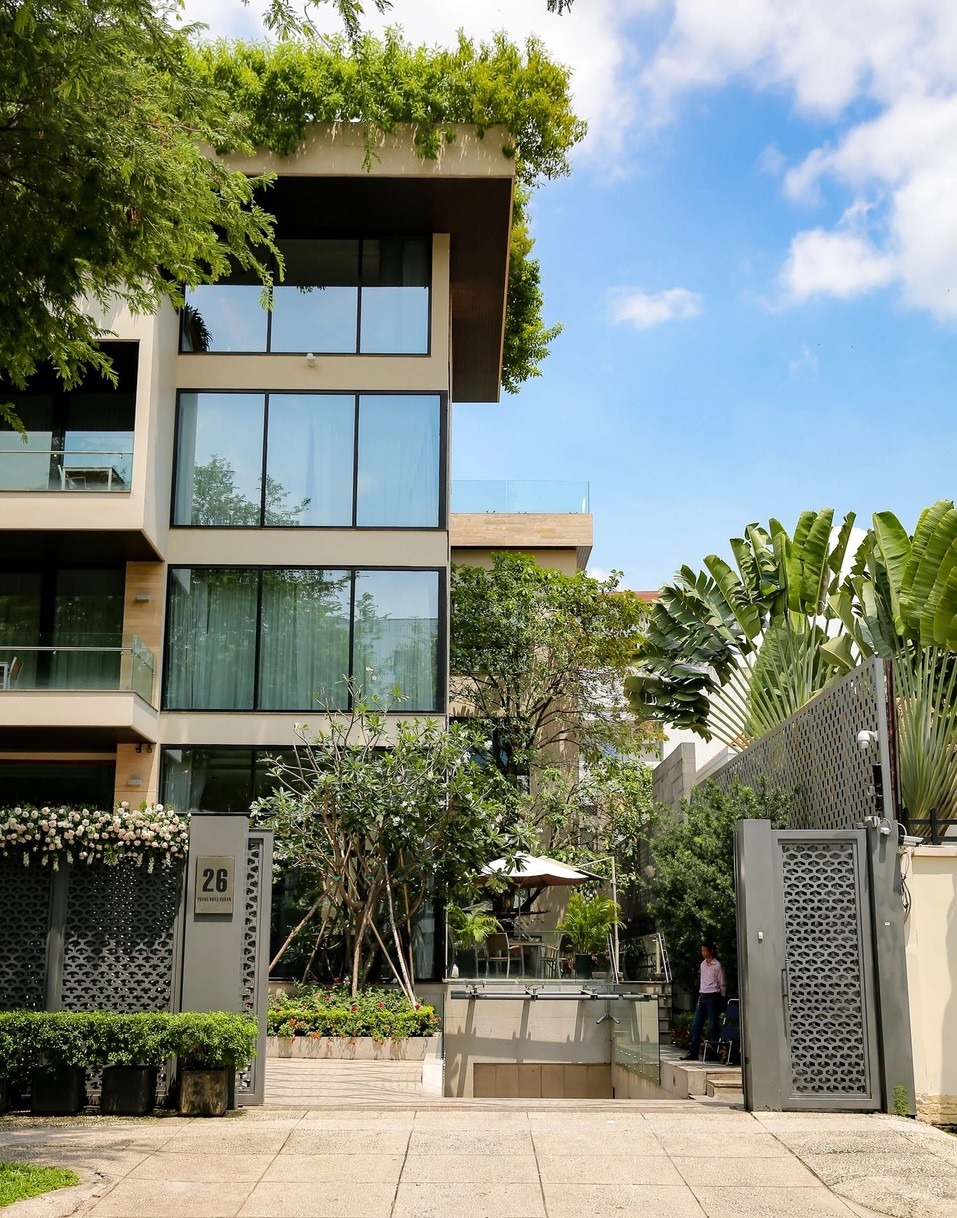 Căn biệt thự nổi bật với thiết kế mái bằng, bề mặt kính cường lực sang trọng được phủ xanh bởi các lớp cây tại các tầng. Ảnh; Zing