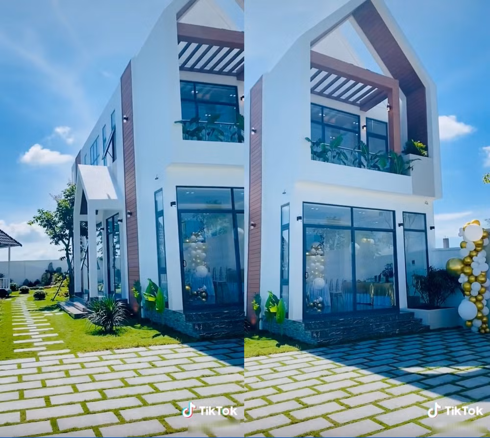 Căn biệt thự có thiết kế 2 tầng có nhiều cửa kính, bên ngoài là sân vườn thoáng đãng với những mảng cỏ xanh mướt. Ảnh: TikTok