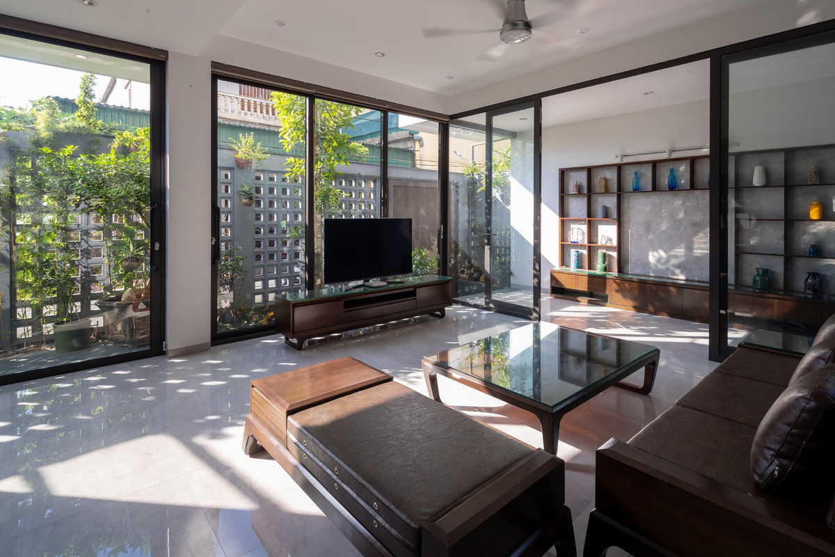 Vách kính mang lại ánh sáng cho không gian phòng khách và nhà bếp.