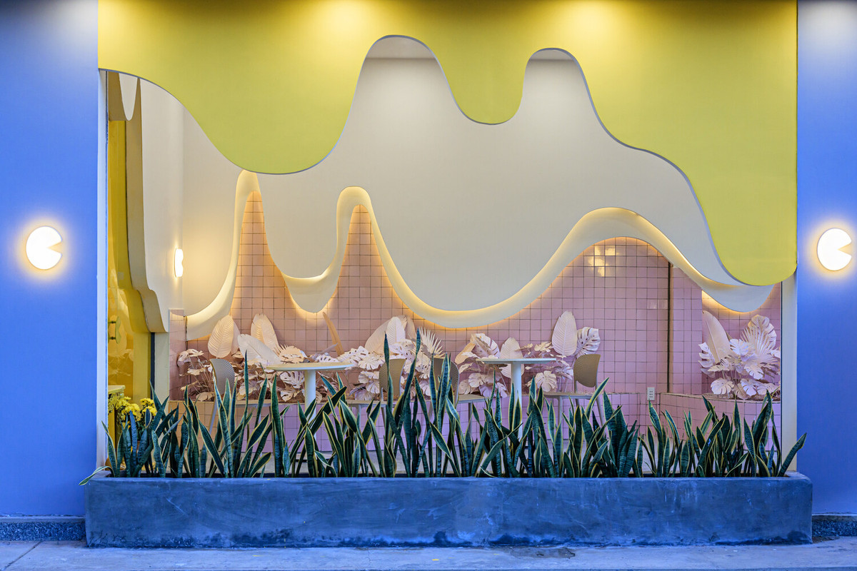 Phủ toàn bộ mặt trước của nhà hàng là màu xám nhạt với những đường nét uốn lượn màu vàng.