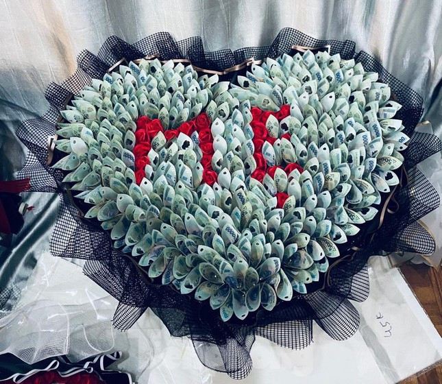 Ngày 8/3 năm nay, có vị khách đặt bó hoa được kết bằng 200 tờ tiền mệnh giá 500 ngàn đồng, tổng trị giá bó hoa là 102 triệu đồng, để dành tặng mẹ. Ảnh: Tiền phong