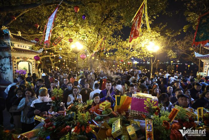 Bên trong sân phủ chật kín người đứng khấn vái. Đồ lễ của bà con đơn giản gồm bánh kẹo, hoa quả và nén hương.