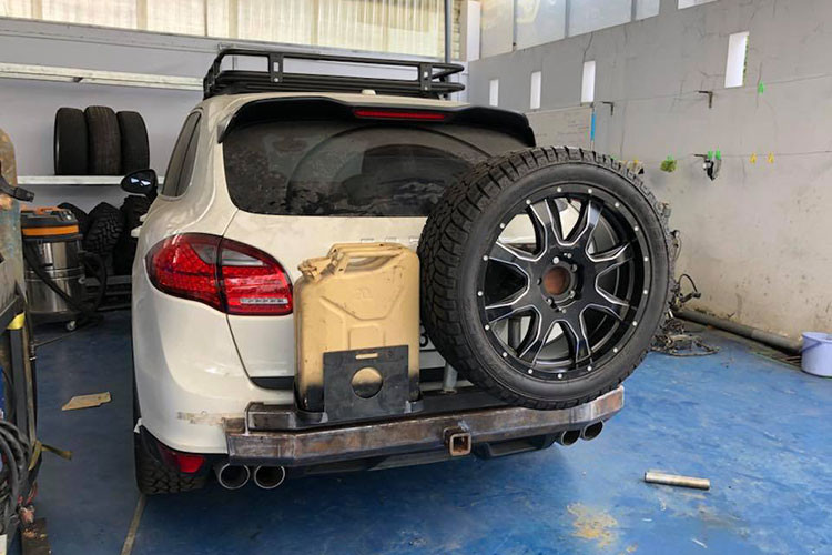 Ở ngoại thất chiếc SUV hạng sang Porsche Cayenne này đã được chủ nhân độ lại cản va trước/sau hầm hố hơn so với xe nguyên bản. Chưa dừng lại đó, chủ nhân chiếc Porsche Cayenne này còn nâng cấp mâm và lốp gai chuyên dụng dành cho xe địa hình nhằm giúp chiếc SUV hạng sang có thể băng rừng lội suối dễ dàng hơn.