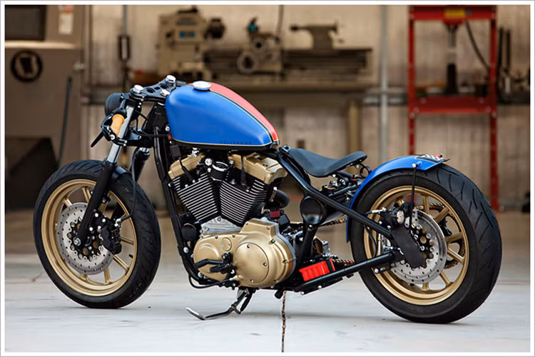 Yên xe hiệu Biltwell còn chỗ để chân là Burly Brand MX Style. Cặp phuộc cũng được làm và sơn theo phong cách tổng thể của xe.