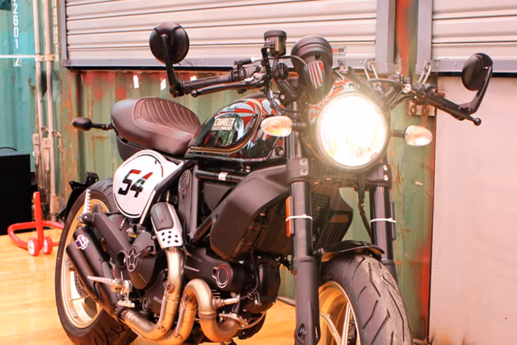 Dựa trên phiên bản Scrambler Full Throttle trước đây, Scrambler Cafe Racer 2017 vẫn sử dụng chung nhiều chi tiết quan trọng như khung chính, phuộc, đèn pha... Ở phía trước, khác biệt đầu tiên của chiếc xe đó là một tấm nhựa bao kín viền đèn pha và phần nối với bảng đồng hồ, khiến chiếc xe trông gọn gàng.