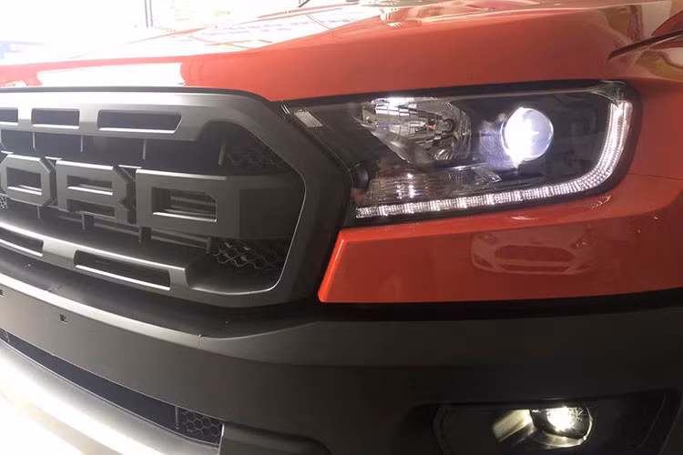 So với màu xanh dương, Ford Ranger Raptor màu đỏ tươi này trông ấn tượng hơn so với màu xanh nguyên bản ở nước sơn. Ngoài ra, gam màu đối lập là đen ở các chi tiết như lưới tản nhiệt, dòng chữ Ford, Raptor hay bộ mâm "hàng thửa" cũng giúp cho bộ áo này trở nên nổi bật.