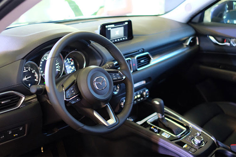 Bên trong nội thất xe cũng thay đổi toàn diện, nhấn mạnh vào triết lý tập trung vào con người. Màn hình giải trí trung tâm của CX-5 cũng nhô lên. Cửa gió điều hòa góc cạnh hơn, dùng vật liệu crôm sang trọng để làm viền. Nút bấm Start/Stop bố trí ra ngoài, không còn nằm sâu sau vô-lăng như đời trước. Vô-lăng thay đổi thiết kế.