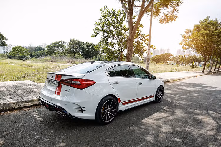 Tô điểm thêm cho thân xe trắng muốt là bộ decal màu đỏ dán dọc theo nắp ca pô đến cốp sau cũng như ở phía hông xe. Trần xe được phủ lên lớp decal chống nóng màu đen tạo cảm giác rộng rãi như có cửa sổ trời. 