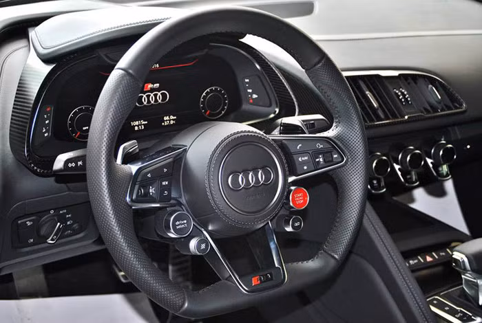 Ngoài ra, siêu xe nhà Audi còn sở hữu vô lăng thể thao 3 chấu tích hợp nhiều phím chức năng cơ bản cũng như công nghệ hỗ trợ người lái, phía sau là màn hình hiển thị thông tin chi tiết các thông số kĩ thuật của xe.