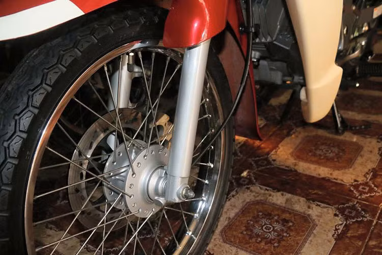 Cặp giảm sóc trước vẫn nguyên bản, lốp và săm có dòng chữ "Made in Malaysia" với gai còn ca0.