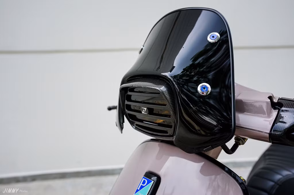 Kính chắn gió màu đen bóng được bắt chặt vào tay lái bằng những con ốc titan 7 màu. Choá đèn sơn khói cùng tấm bảo vệ hầm hố, lấy cảm hứng từ mặt nạ của những võ sĩ đấu kiếm Nhật Bản. Viền đèn pha được đổi từ chất liệu chrome sang carbon. 