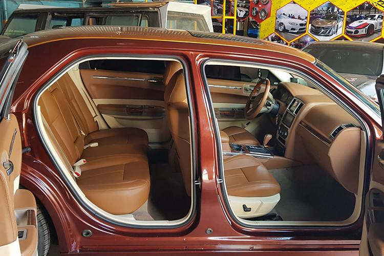 Bên trong nội thất, chiếc Chrysler cũ độ xe sang Phantom sở hữu không gian cabin sang trọng với tông màu nội thất chủ đạo là màu nâu da bò. Ngoài ra, gần như toàn bộ không gian cabin này cũng đều được bọc da, ốp gỗ với một số chi tiết bọc cả carbon lạ mắt.