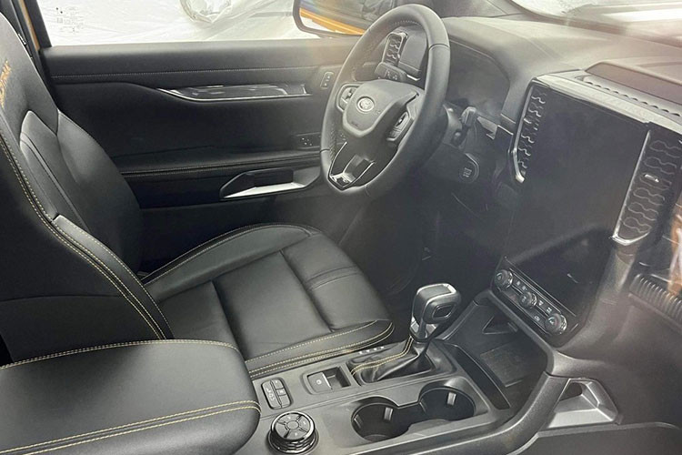 Qua hình ảnh có thể thấy, nội thất của Ford Ranger Wildtrak 2022 sẽ có đầy đủ trang bị tiện nghi và an toan không thua kém phiên bản được bán tại Thái Lan. Xe có phanh tay điện tử, núm xoay chuyển cầu, nút bấm chuyển chế độ lái, màn hình giải trí thiết kế dọc kích thước 12 inch và điều hoà tự động 2 vùng. Trên gương chiếu hậu cũng có camera của hệ thống camera 360 độ quanh xe.