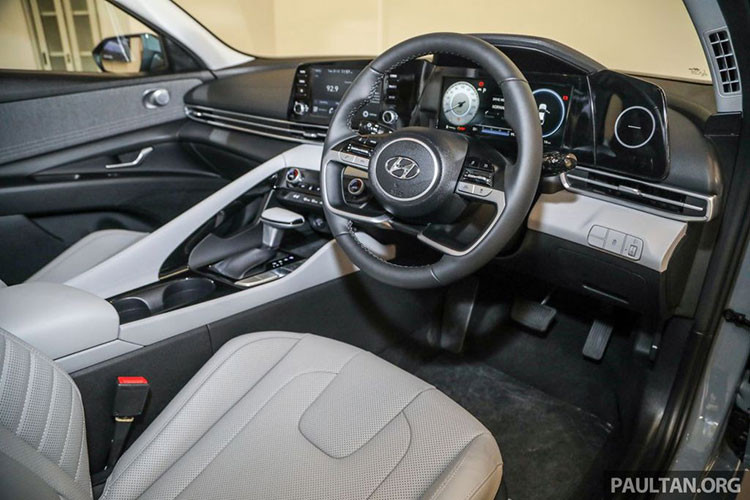 Nhìn sang bên trái, vô-lăng 4 chấu là điểm nhấn ở khoang nội thất trên Hyundai Elantra 2021 có ảnh hưởng từ Tucson và tích hợp đầy đủ phím bấm. Ở phiên bản Premium, Hyundai Elantra 2021 sẽ được trang bị màn hình kỹ thuật số 12,3 inch, trong khi đó đây là bản cấp thấp nên cụm đồng hồ dạng Analog kết hợp màn hình 4 inch đặt lệch bên phải.