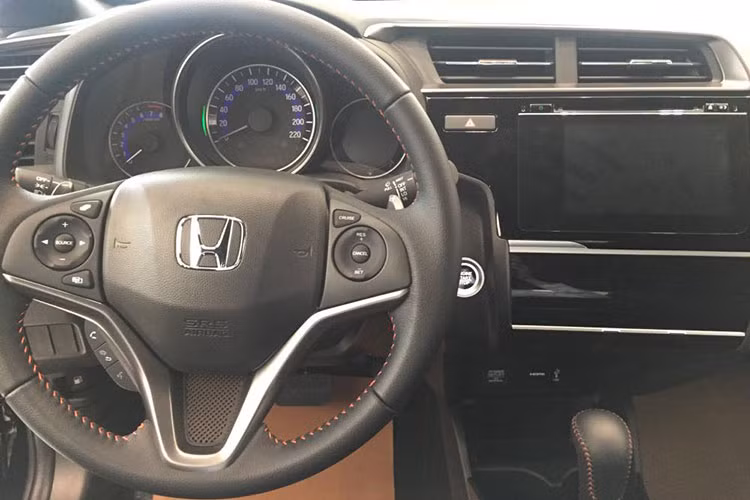 Bảng điều khiển trung tâm của xe với màn hình cảm ứng 7 inch, hỗ trợ kết nối smartphone, HDMI hay USB. Camera lùi cũng được hiển thị trên màn hình này. Bản RS có điều hòa tự động. Về mặt tiện ích, Honda Jazz cũng rất phong phú với điều hòa tự động, ổ cắm 12V, khe USB, nhiều hộc đựng đồ bố trí khắp khoang xe...