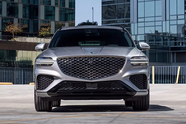 Genesis GV70 sở hữu thiết kế ngoại thất khỏe khoắn với dáng xe chắc chắn, bệ vệ nhưng không kém phần phong cách và thể thao. Đầu xe vẫn là bộ lưới tản nhiệt hình chiếc khiên Crest Grille, đi kèm cụm đèn pha LED hai tầng cùng 4 dải đèn chiếu sáng ban ngày chạy song song.