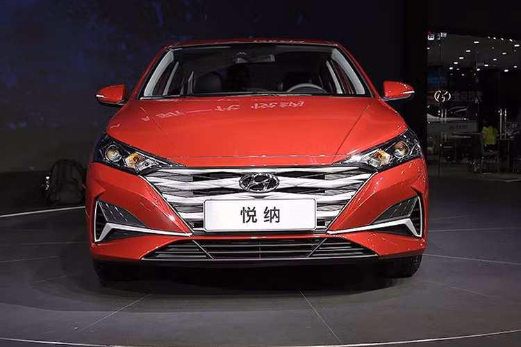 Phần đầu xe Hyundai Accent nâng cấp 2020 với nhiều chi tiết mạ crome, đáng chú ý - lưới tản nhiệt Cascading Grille với 4 nan mạ crôm nằm ngang dày dặn. Nằm hai bên lưới tản nhiệt là cụm đèn pha hoàn toàn mới, được thiết kế như kéo dài đến gần hết nắp capô. Tạo hình bên trong cụm đèn pha mới khá sắc sảo và đi kèm cả dải đèn LED định vị ban ngày.