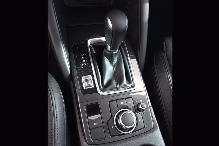 Ngoài vô lăng bọc da, thêm một số chi tiết crom cùng các nút bấm đa phương tiện đi kèm, cần số cũng được bọc da và mạ crom mới. Căn cứ vào hình ảnh có thể thấy, mẫu SUV này còn được trang bị hệ thống Mazda Connect mới nhất.