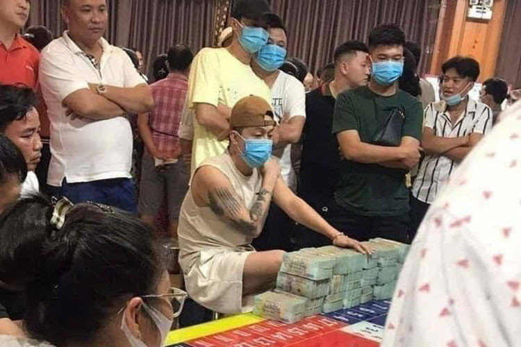 Hình ảnh nam ca sĩ Ti Ti đánh bạc từng gây xôn xao mạng xã hội, thú vị hơn, khi đứng phía sau anh, người mặc áo thun vàng, đội mũ màu đen chính là Phan Công Khanh.