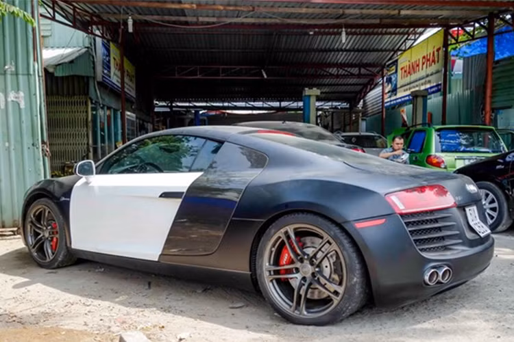 Đây cũng là chiếc siêu xe Audi R8 đầu tiên của vị đại gia đình đám này. Điểm gây ấn tượng trên bản độ này chính là nước sơn xám mờ cùng hai cánh cửa trắng tương phản. Theo giới mê xe cho hay, trước đây chiếc siêu xe Audi R8 này nguyên bản mang màu trắng.