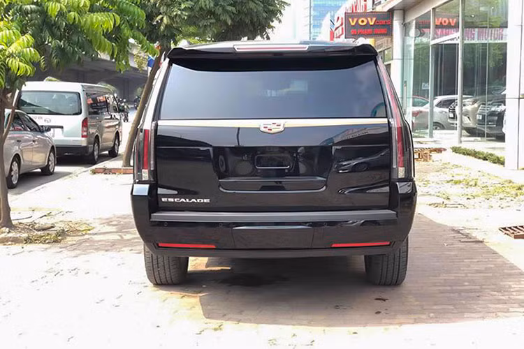 Cụm đèn hậu là một dải đèn LED đặt dọc phần góc đuôi xe tạo nên điểm nhận diện không lẫn vào đâu của Cadillac Escalade. Gương chiếu hậu chỉnh điện tích hợp đèn xi-nhan báo rẽ. Logo Cadillac gắn trên nẹp kim loại mạ chrome sáng tại đuôi xe, phía dưới là camera lùi nằm trong hệ thống camera 360 độ.