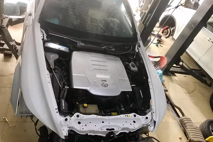 Sau khi sơn xong, các chi tiết như mặt ca-lăng hình "đồng hồ cát" đặc trưng của Lexus mới được gắn vào trung tâm đầu xe. Được biết, quá trình độ lại chiếc Lexus LS460 2007 lên đời 2017 này của showroom xe sang Nghệ An không có sự can thiệp nào vào kết cấu động cơ.