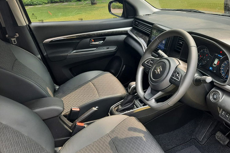 Bên trong Suzuki XL7 Hybrid 2023 vẫn là không gian nội thất 7 chỗ như trước nhưng phối màu xám - đen mới, đi kèm những chi tiết ốp gỗ bóng màu đen. Mẫu MPV này có thêm một số trang bị như gương chiếu hậu kỹ thuật số cảm ứng ở bản Alpha và hệ thống kiểm soát hành trình.