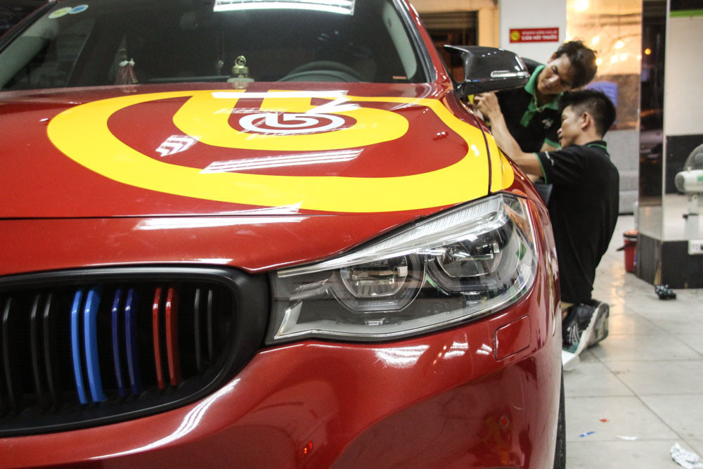 Mẫu BMW 3 Series GT có màu sơn đỏ nguyên bản được tô điểm thêm bằng các họa tiết màu vàng. Ngôi sao vàng nổi bật 2 bên cửa tượng trưng cho quốc kỳ Việt Nam.