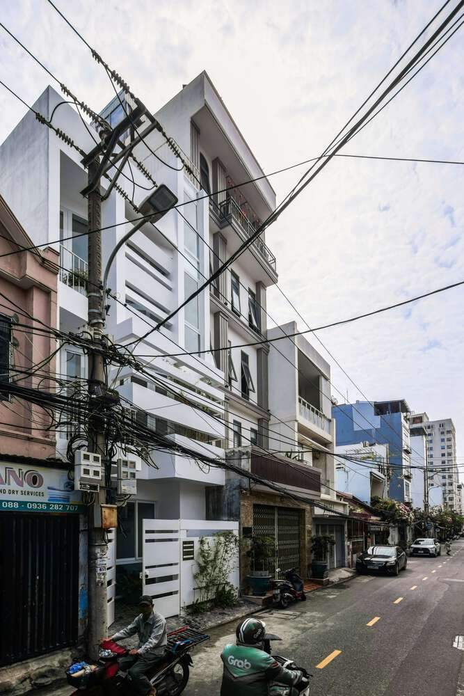 Mặt tiền hướng Tây được thiết kế với hệ lam bê tông nằm ngang, giúp hạn chế ánh nắng gay gắt của buổi chiều. Ảnh: D inh R