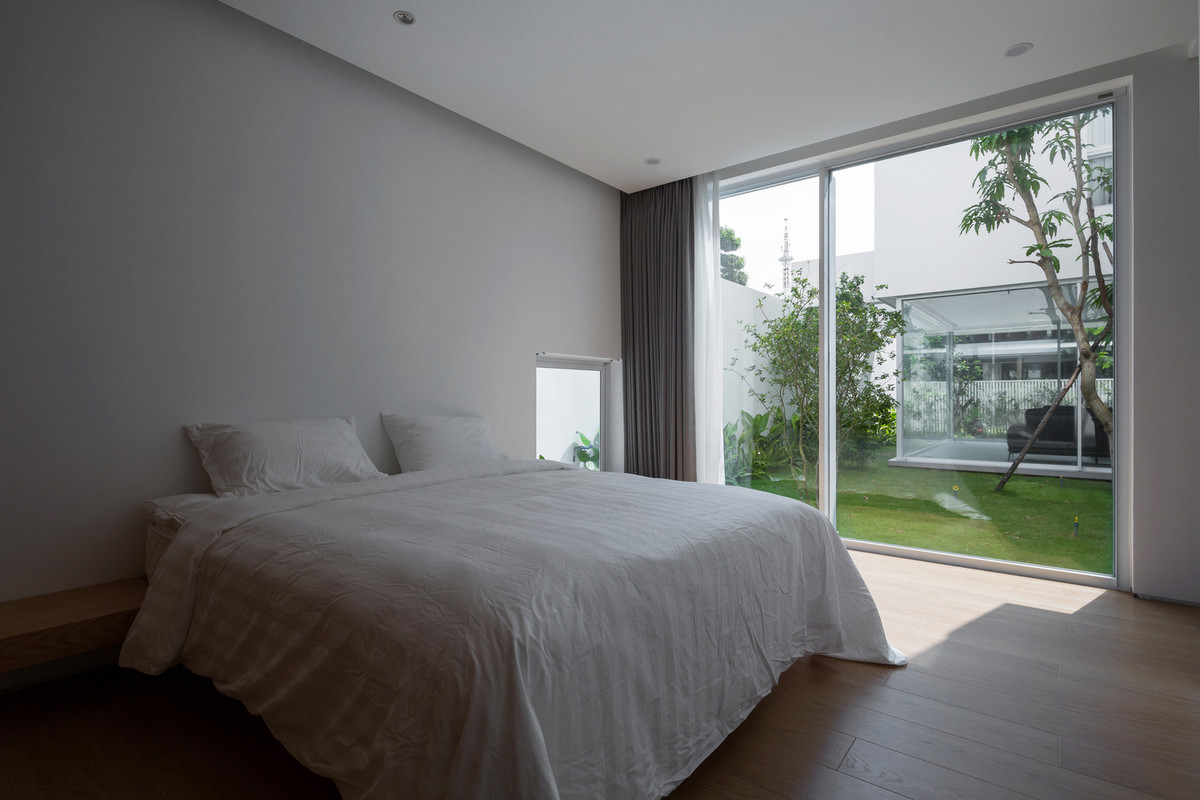 Phòng ngủ tối giản với gam màu trắng chủ đạo, ngập tràn ánh nắng. Ảnh: Hoàng Lê