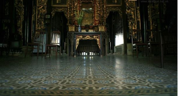 Chính giữa ngôi nhà là gian thờ uy nghiêm, nơi đặt các bức hoành phi lớn cùng hệ thống cột kèo được chạm khắc hoa văn cầu kỳ. Ảnh: Vntrip