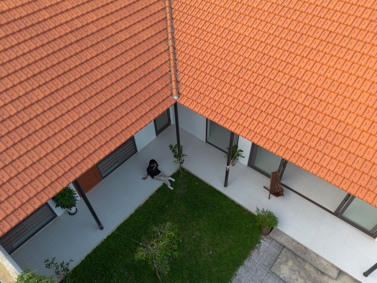 Nhìn từ bên ngoài, ngôi nhà mang đến cảm giác mộc mạc, thân quen với những hình khối đơn giản, vật liệu bản địa như đá, gỗ, và mái ngói đỏ...Ảnh: Lê Trung