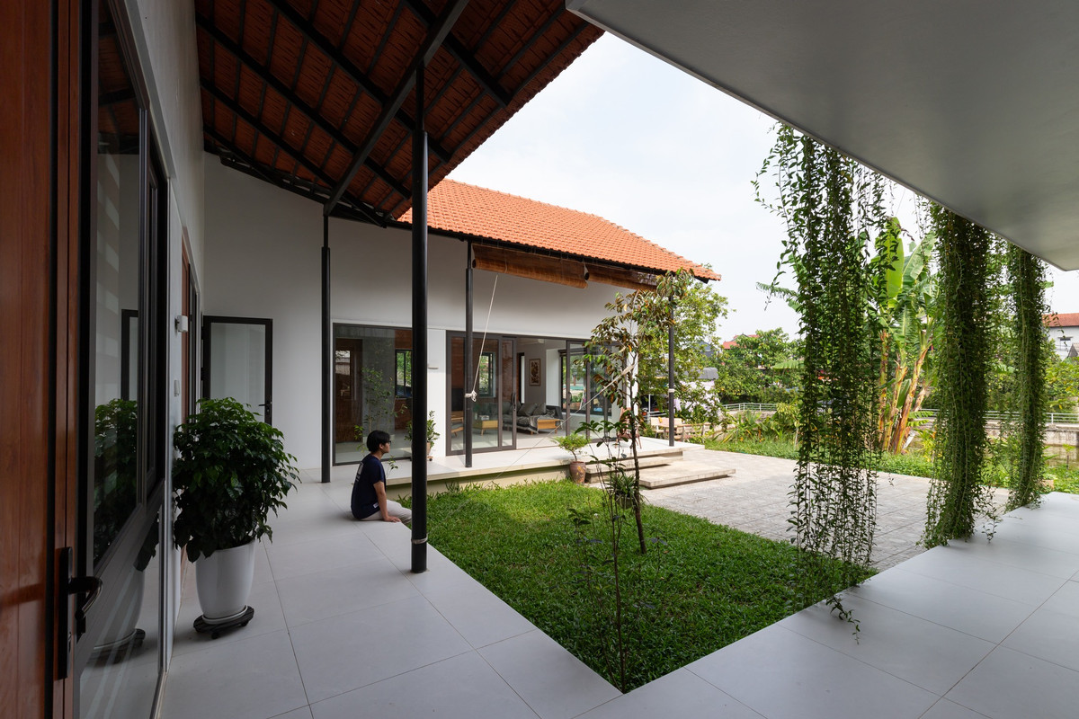 Mái hiên lớn bao xung quanh là khoảng không gian đệm, kết nối giữa trong và ngoài căn nhà. Ảnh: Lê Trung
